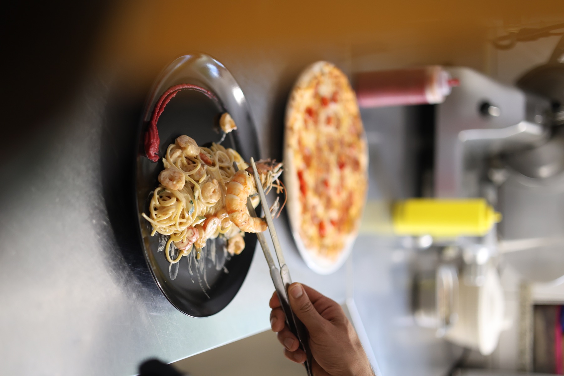 Seafood pasta being finished in the kitchen