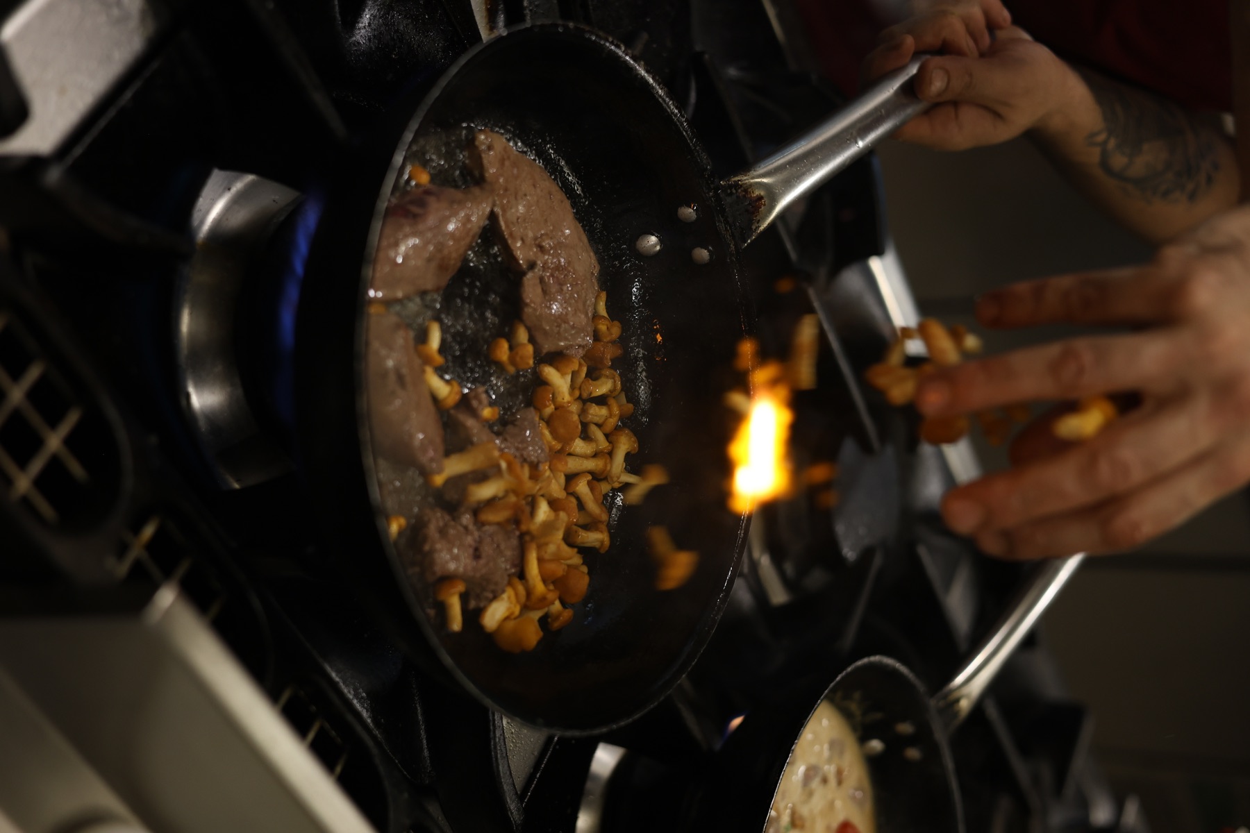 Meat and mushrooms cooked over flame